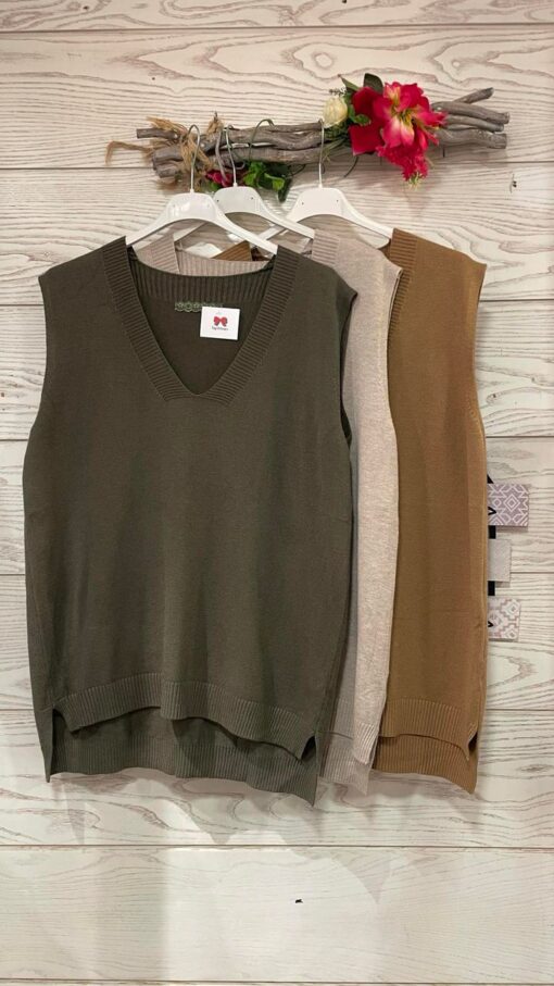 Jersey de punto tipo chaleco, cuello en V, pequeñas aberturas laterales, borde y detalle del cuello acanalado y bajo asimétrico. Estilo casual.